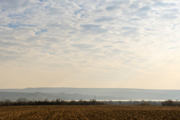 Fototapeta premium Rural scenery in Moldavia, along the national road E85. View towards Siret river