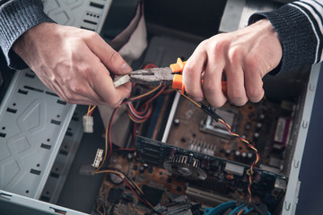 Man repairs computer.