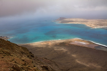 view of a volcanic landscape with lava and some plants on the island of lanzarote similar to the lunar aspect