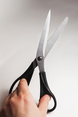metal tailor sewing scissors with black big and small rings in hand