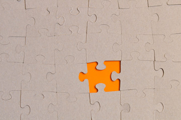 Fototapeta premium Jigsaw puzzles on orange background. The concept of development of thinking.