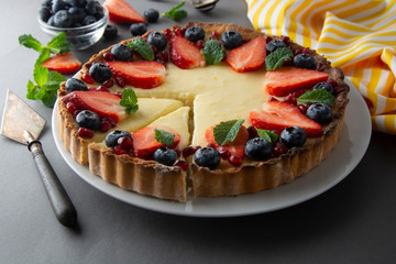 Cheesecake with fresh berries and mint for dessert - healthy organic summer dessert pie cheesecake. Cheese cake. Gray background.