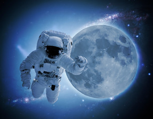 Fototapeta na wymiar astronaut levitate in space in front of moon. elements of this images furnished by nasa