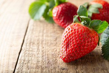 Fresh, tasty summer strawberrie. close up ripe strawberry on wooden board. Summer day light.