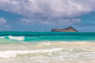 Beautiful Waimanalo beach with turquoise water and cloudy sky, Oahu coastline, Hawaii