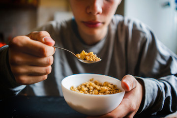 handsome man eat  dry cereal on a breakfast
