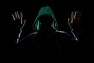 cought by police suspect with raised hands in the dark place at night