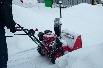 Snow clearing. Snowblower clears the way after heavy snowfall.