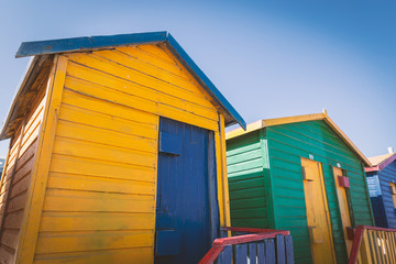 Naklejka premium Muizenberg beach with colorful wooden cabins in Cape Town, South Africa