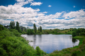 Beautiful small lake and green hills in New Zealand