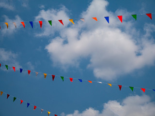 Colorful of flags on blue sky with clouds background in carnival fair