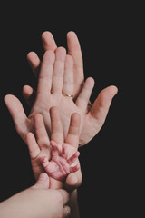 hands of whole family. Father, mother, son and a baby. Friendly happy family - 258701233