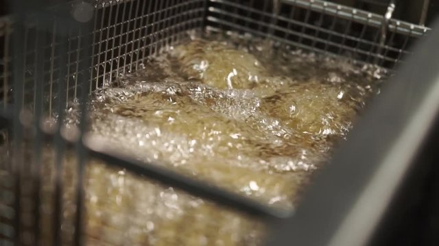 close up Deep fryer with boiling oil on fast food kitchen