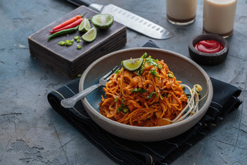 Indian mee goreng or mee goreng mamak, Indonesian and Malaysian cuisine, spicy fried noodles in a plate, copy space - 258702860