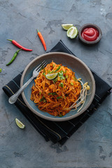 Indian mee goreng, spicy fried noodles in a plate, Singaporean and Malaysian cuisine copy space - 258703243