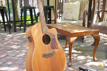 Rustic vintage acoustic guitar infant of vintage couch and lounge chairs