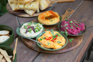 Dips served on a rustic platter 