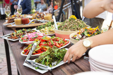Serving food at a large outdoor, alfresco bbq