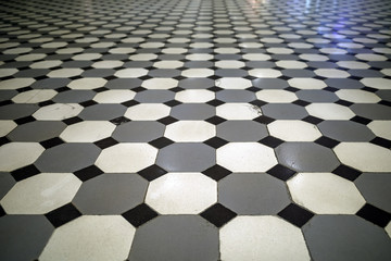 View of the old floor lined with black white and gray ceramic tiles