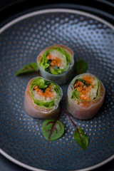 nori free maki sushi with carrots salad and salmon no seaweed on dark plate