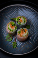 nori free maki sushi with carrots salad and salmon no seaweed on dark plate