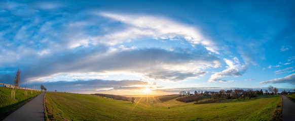 Sunrise in spring field at early morning
