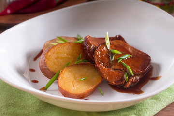 Fried potatoes and meat slices in sauce, simple country dish