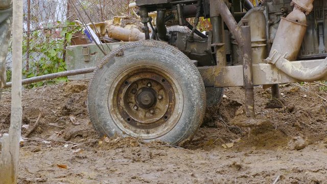 pulling a rusty improvised rig out of mud