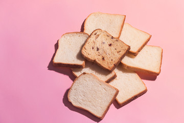 Sliced bread to toast isolated on pink background. Close up. Top view