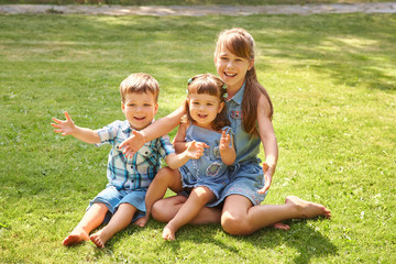 Naklejka na ściany i meble playful children outdoors in the summer on the grass in a backyard