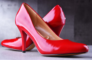 Composition with a pair of red high heel shoes