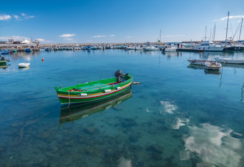 Fototapeta premium A colorful variety of boats and ships fill the docks of the harbors of Syracuse (Siracusa), a historic city on the island of Sicily, Italy.