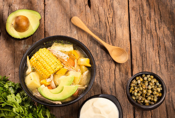 Colombian cuisine: ajiaco soup with chicken and vegetables close up in a bowl.