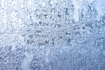 Real ice on frozen window in winter time background