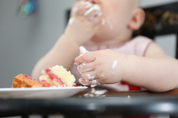 eating birthday cake with two hands