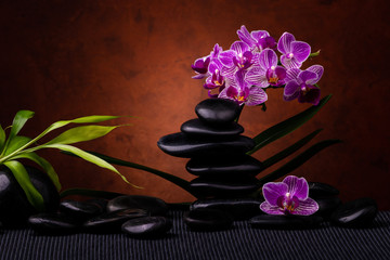 Obraz na płótnie Canvas Spa, concept. composition with bamboo, orchid flowers and black stones