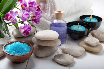 composition of the spa treatment. Candles in bowls with water, bath salts, and orchid flowers.