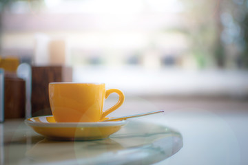 A coffee cup on the breakfast table with country view in the cafe