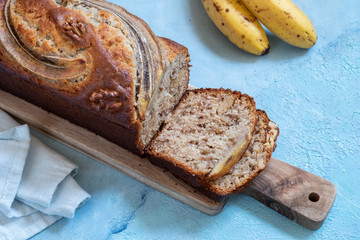 Sliced banana bread loaf with a walnuts