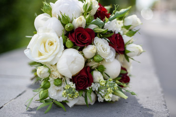 Wedding bouquet in hands and bride's dress