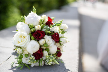 Wedding bouquet in hands and bride's dress