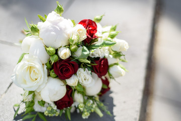 Wedding bouquet in hands and bride's dress