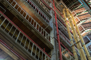 Industrial background, old abandoned factory hall with stairs and day light