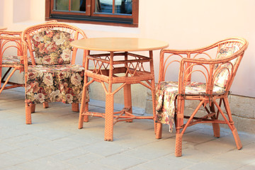vintage chairs and table stand outside on a summer day