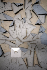 Light switch and worn paint on the wall in abandoned building in Southern Finland. 