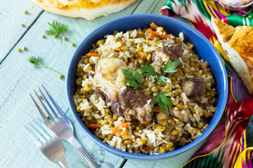 Arabic cuisine. Events Ramadan. Middle Eastern Mashkichiri (porridge made of rice, beef and mung bean) on wooden table. Top view flat lay background. Copy space.