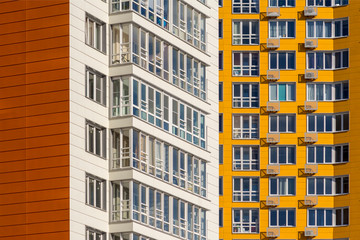 Two new high-rise residential buildings. White and yellow houses in new area