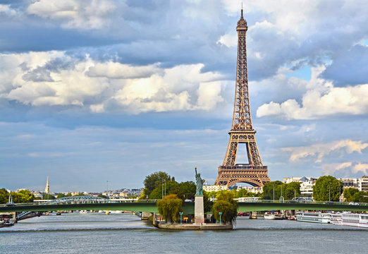 Eiffel Tower, Seine river and Statue of Liberty in Paris, France.