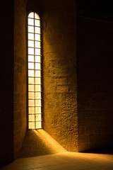 Sun shining through a narrow church window