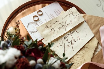 Naklejka na ściany i meble Wedding invitation with wedding rings and flowers